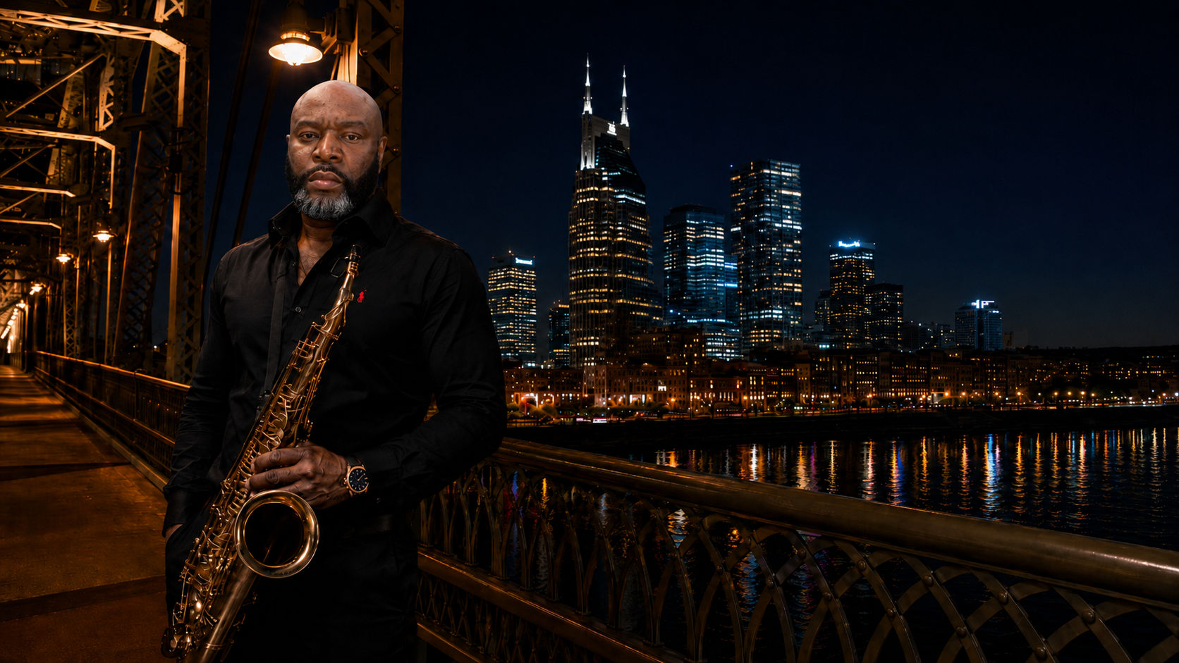 Larry Love with his saxophone on a Nashville bridge at night, city skyline behind him